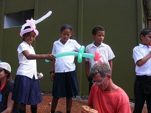 Local Kids playing with ballon animals made by Global Village Team