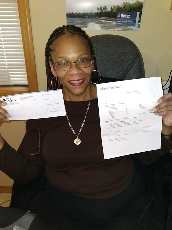 Carla holding her final home payment check.