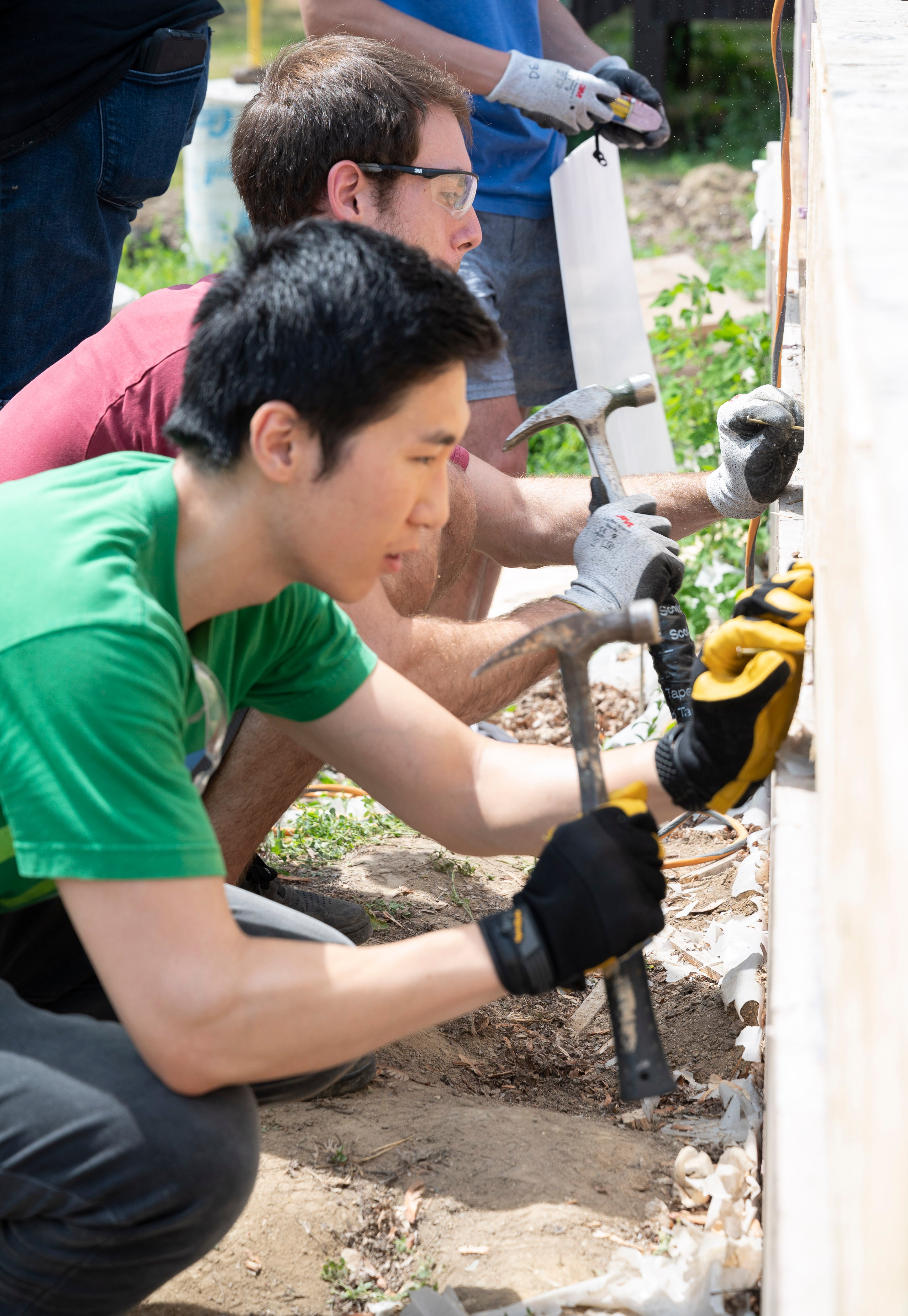 volunteers with hammers