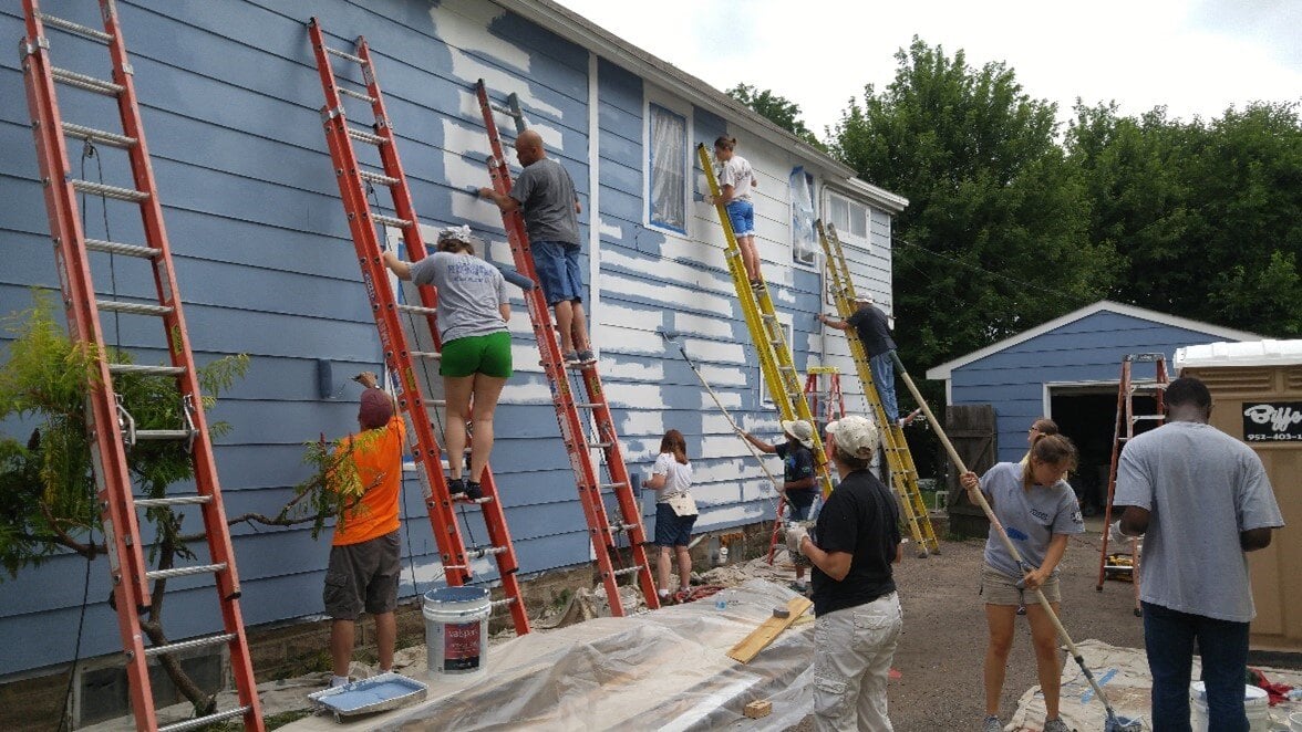 Volunteers painting a home through A Brush with Kindness program