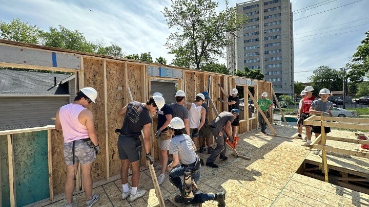 Group of students working on a construction site.