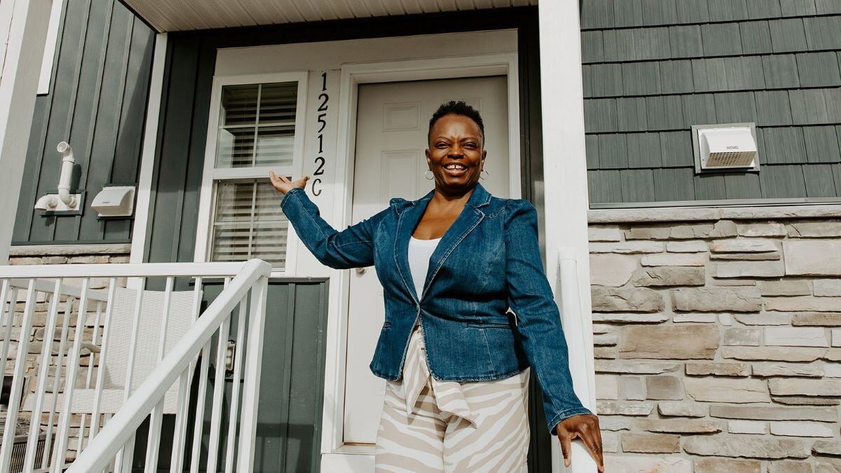 Bridgette smiling outside her townhome.