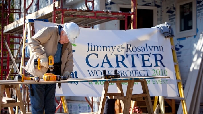 President Carter using a power drill at the 2010 Carter Work Project.