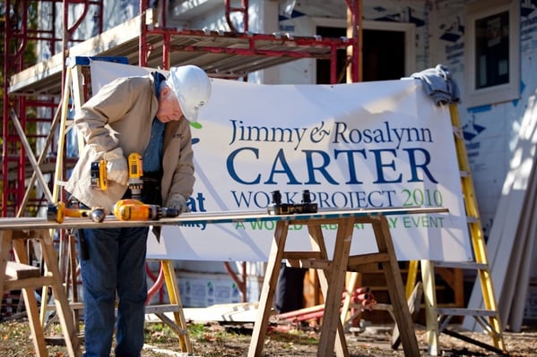 President President Carter using a drill on a build site.