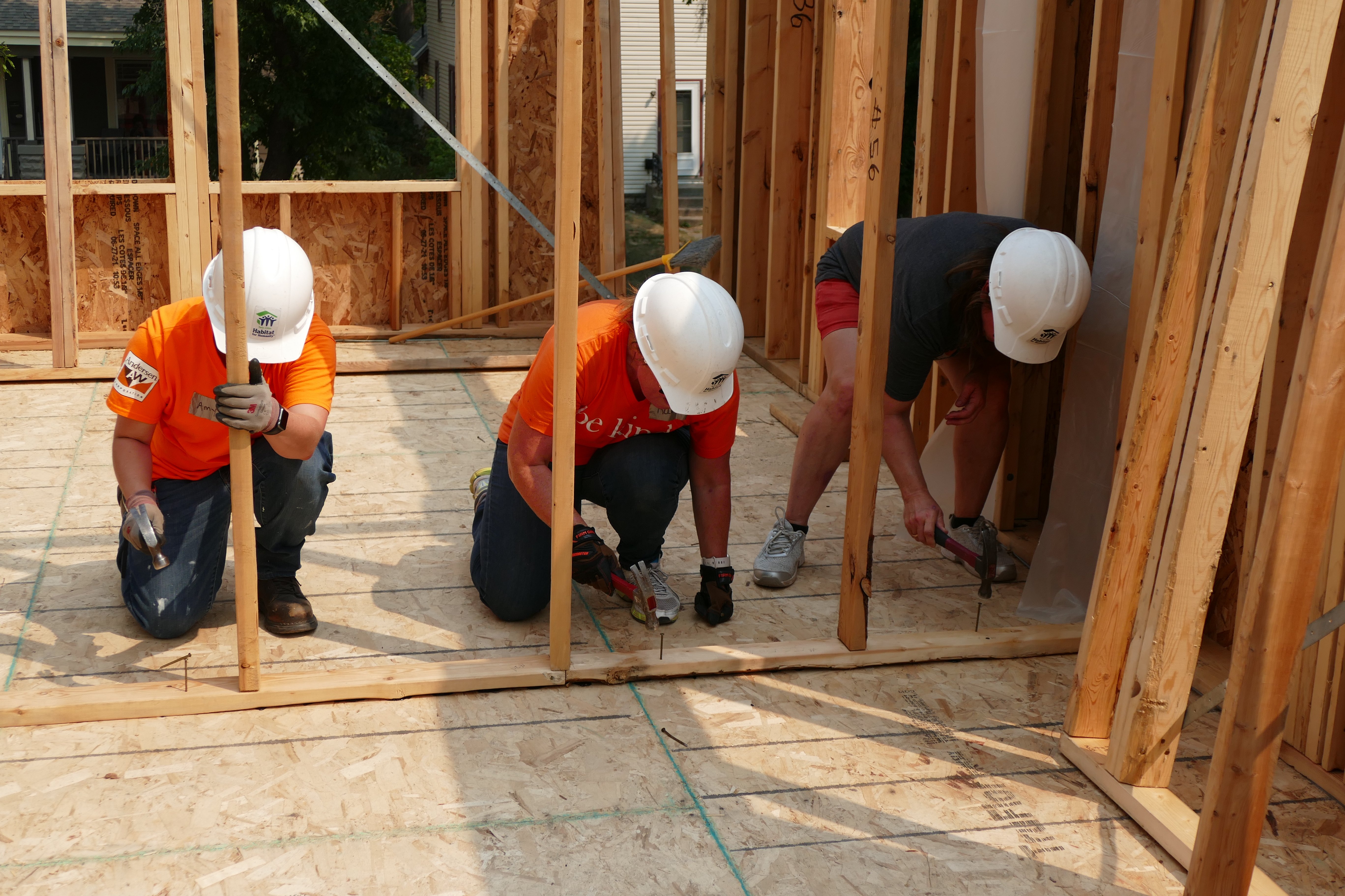 Andersen volunteers working on wall