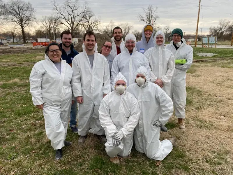 AmeriCorps members posing in a group in protective equipment.