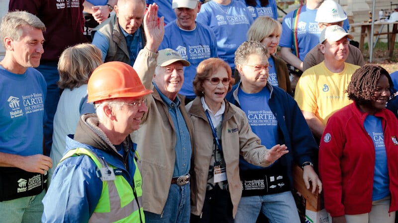 Jimmy and Rosalynn Carter waving to crowds.