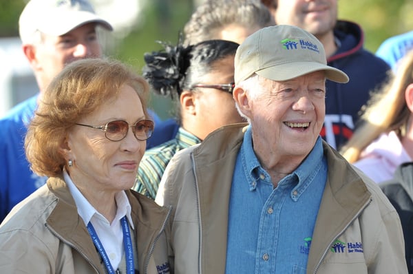 The Carters smiling for a photo during a Carter Work Project.