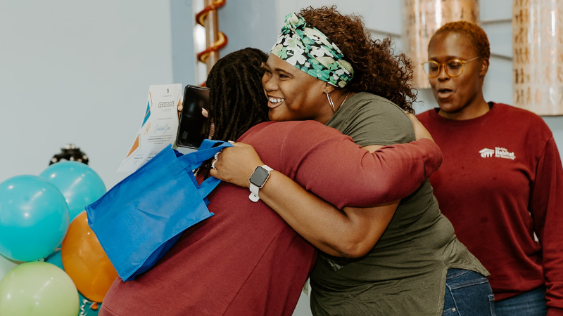 Program participant hugs.