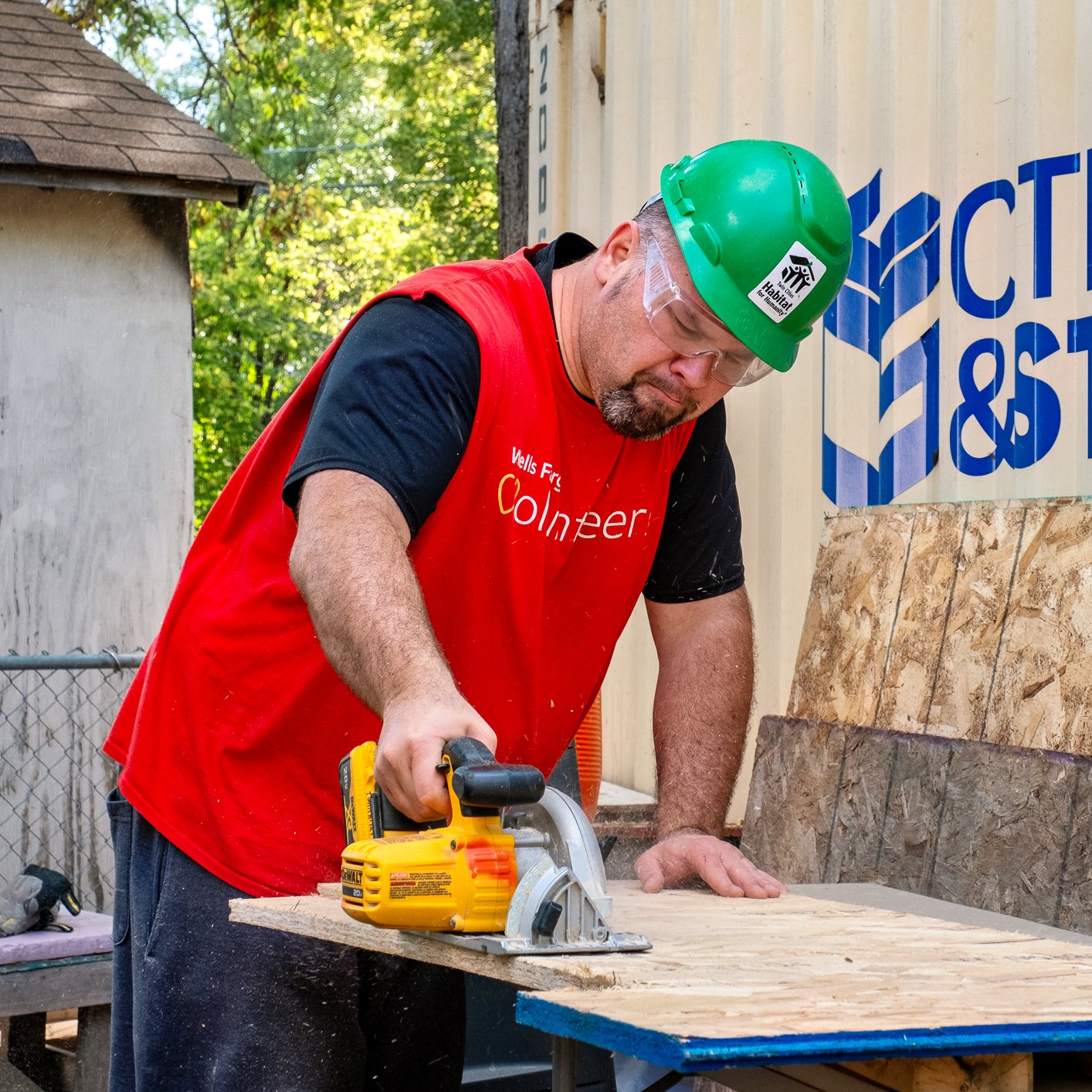 Volunteer using saw.