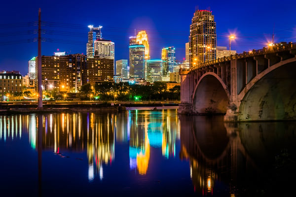 The Central Avenue Bridge and skyline reflecting in the Mississippi River at night, in Minneapolis, Minnesota.