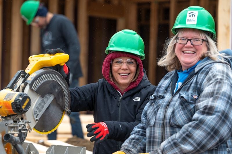 Two SMSC volunteers using saws.