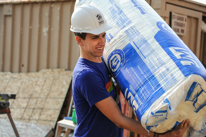 Rainbow Build 2021 volunteer carrying siding