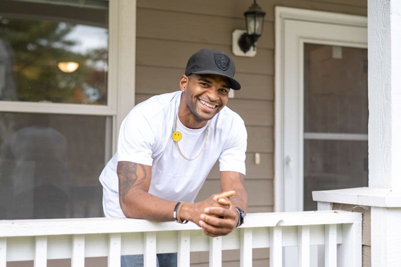 James smiling on his front porch