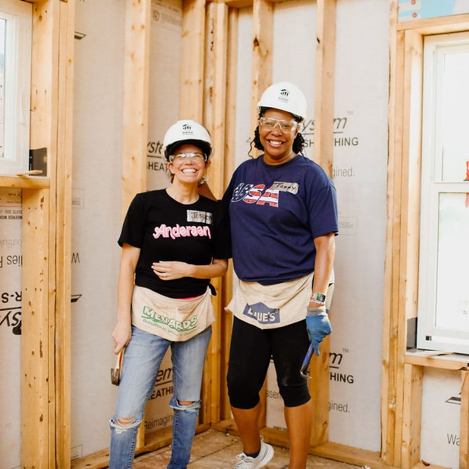 Two volunteers smiling together